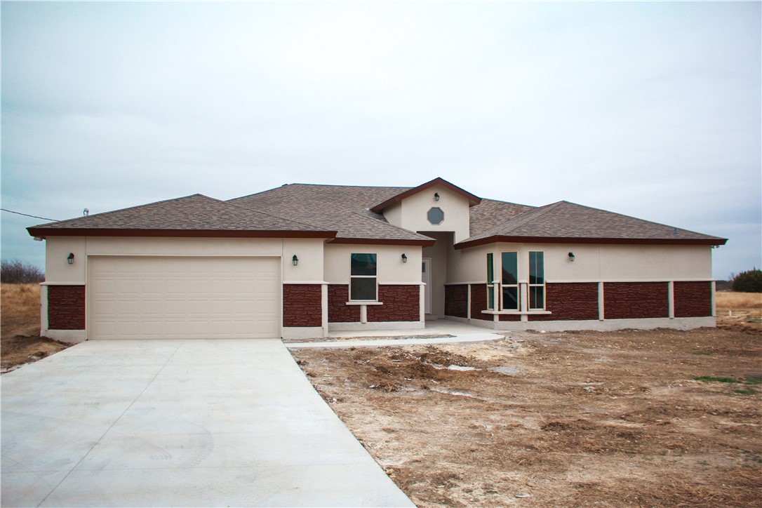 a view of a house with a yard and sitting area
