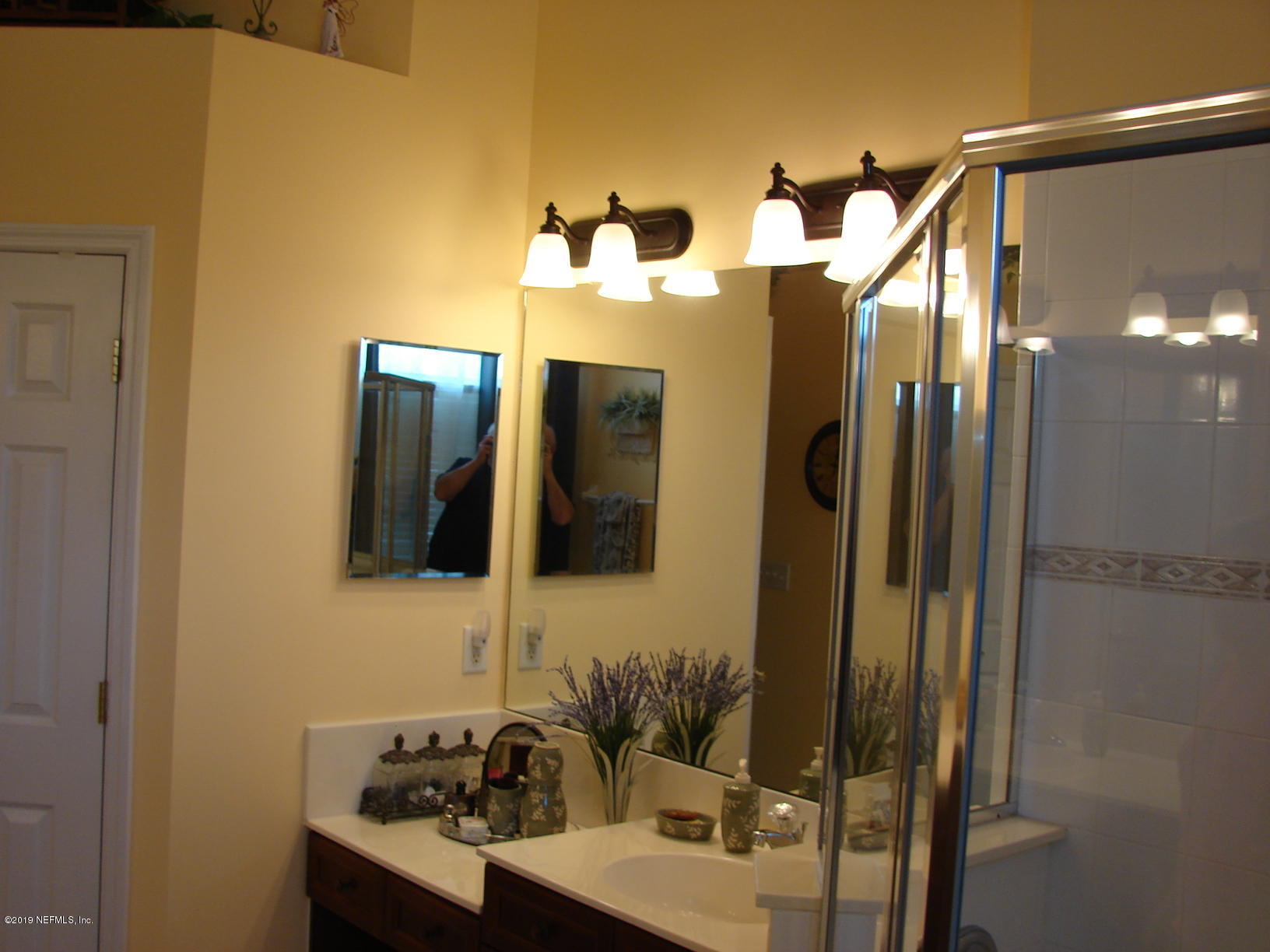 1535 Royal County Drive Jacksonville, FL 32221 - Photo 14 of 38 a bathroom with a sink and a mirror