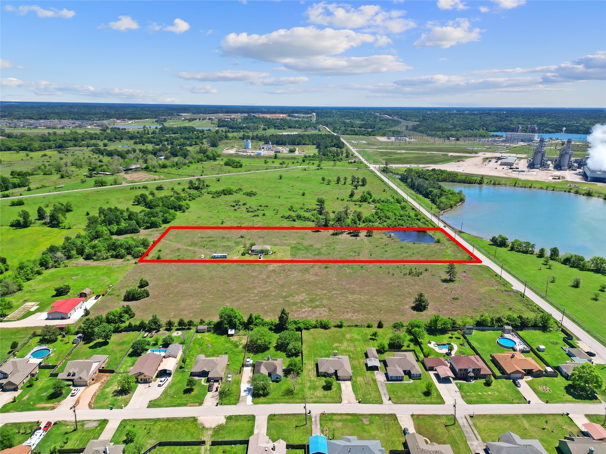 a view of swimming pool with a garden and plants