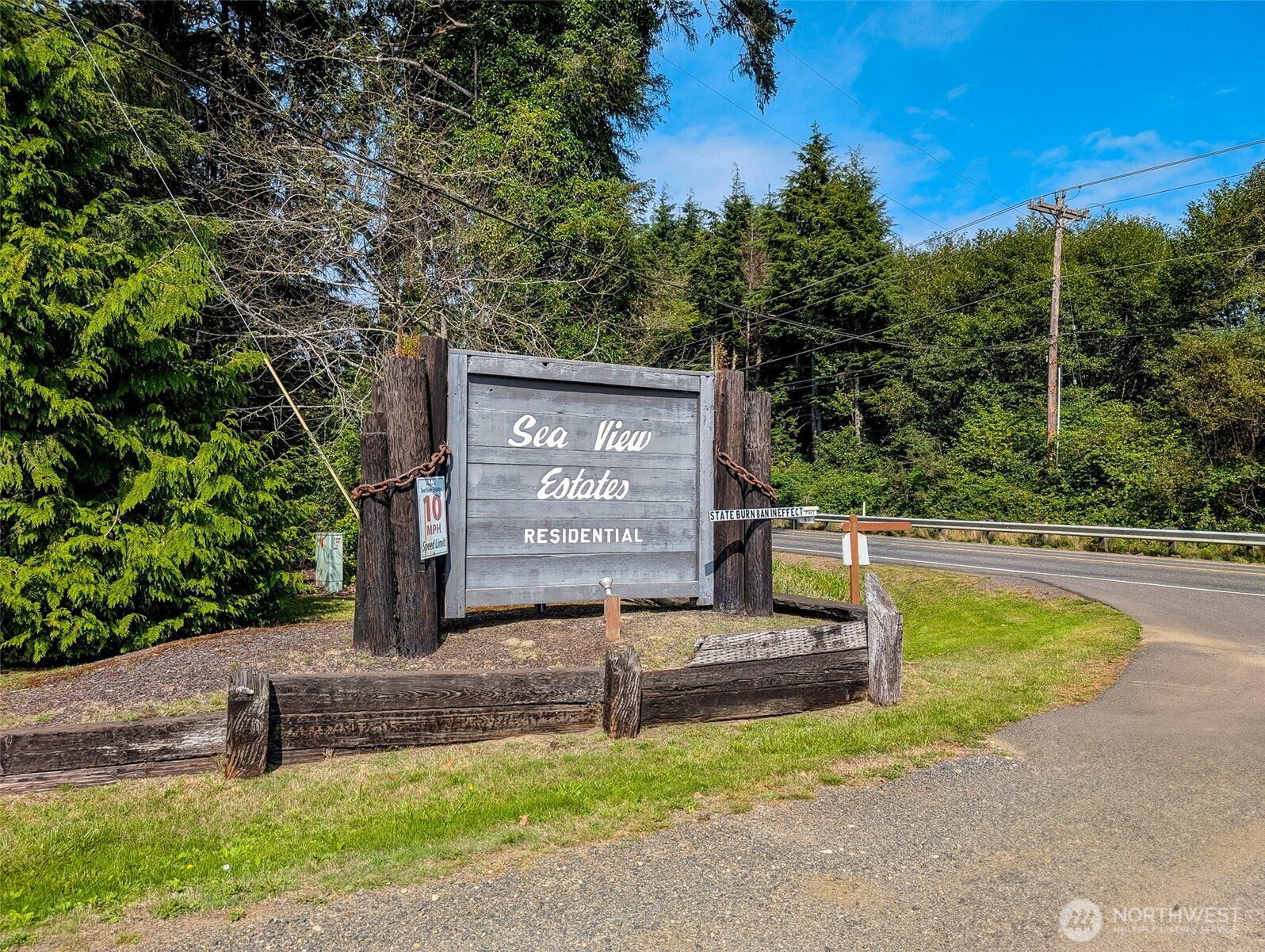 2 Dolphin Street Copalis Beach, WA 98535 - Photo 5 of 40 a view of a street with benches sitting next to a road