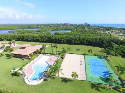 an aerial view of a houses with outdoor space swimming pool and outdoor seating