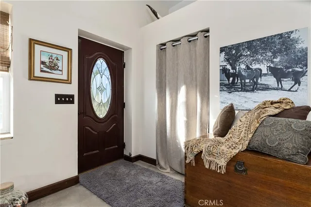 a dining room with kitchen island stainless steel appliances furniture a rug and a view
