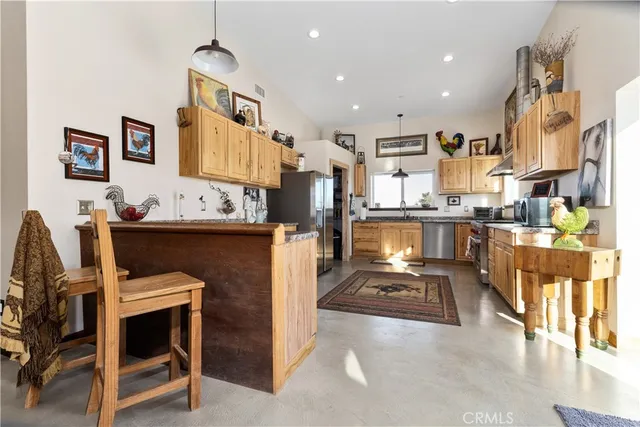 a kitchen with stainless steel appliances granite countertop a stove and cabinets