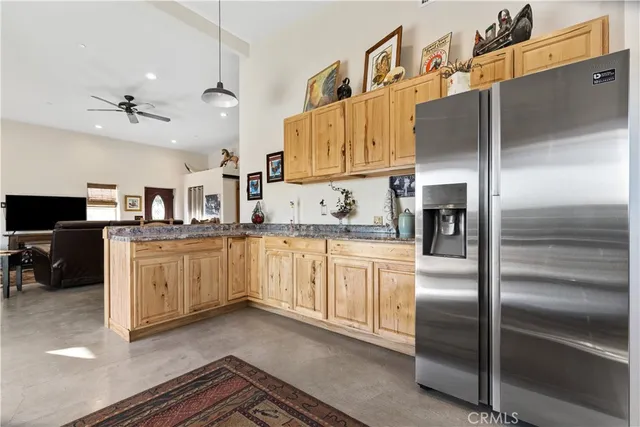 a view of a workspace with furniture and a flat screen tv