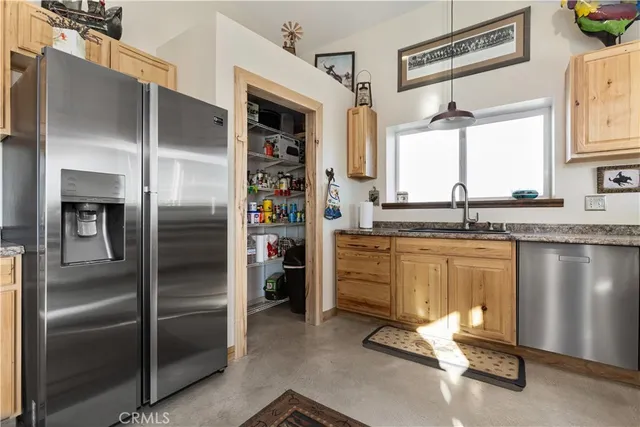 a view of a workspace with furniture and a flat screen tv