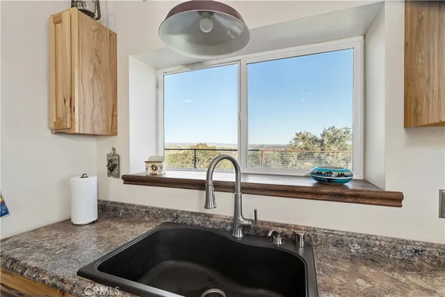 a bathroom with a double vanity sink and a window