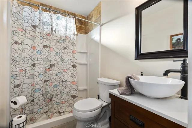 a view of a house with a wooden fence