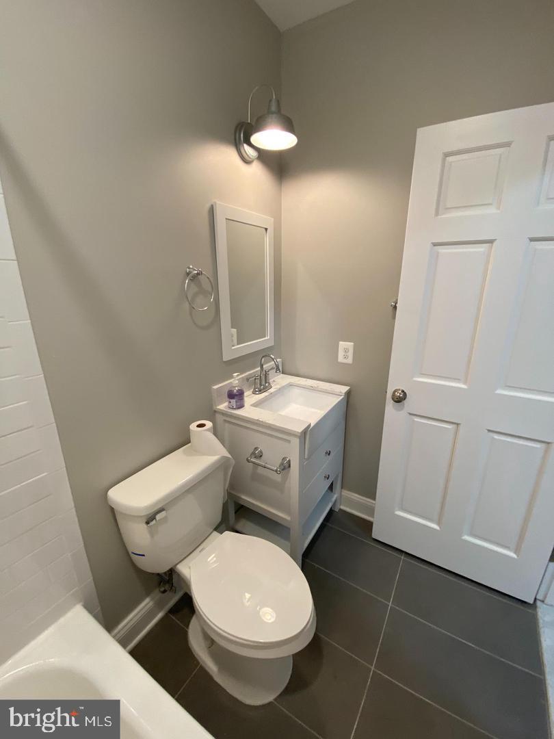 325 East 21st Street Baltimore, MD 21218 - Photo 22 of 28 a bathroom with a toilet sink and mirror