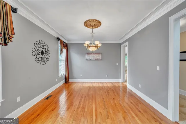 a spacious bedroom with a bed and a chandelier