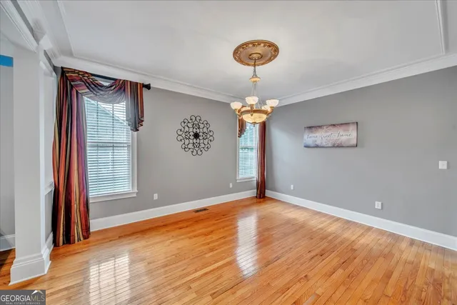 a spacious bedroom with a bed and a chandelier