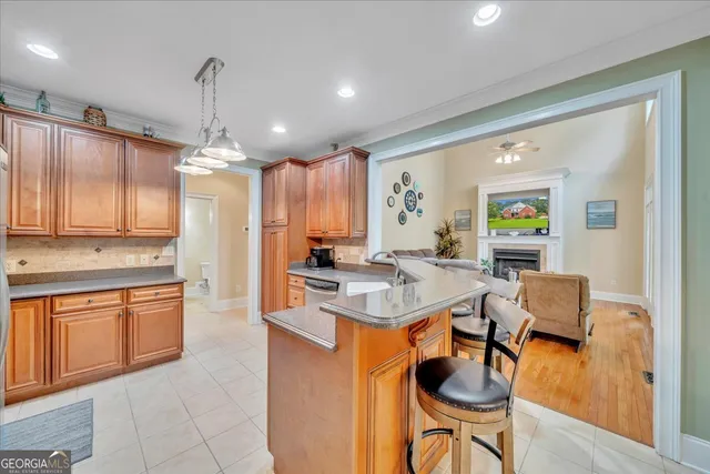 a kitchen with stainless steel appliances granite countertop a stove a refrigerator and a microwave