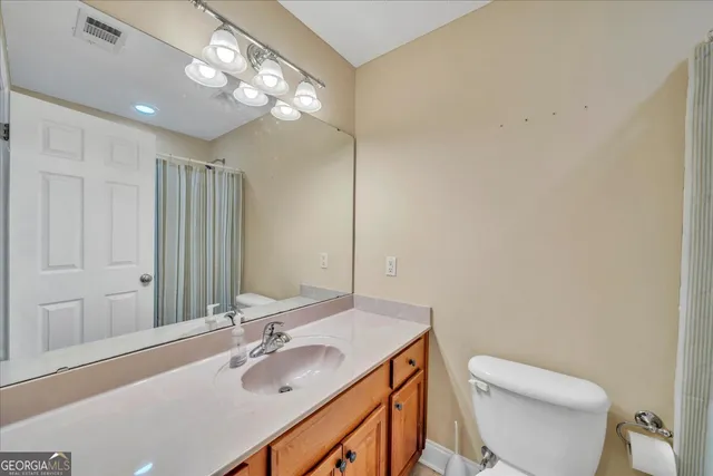 a bedroom with furniture and a chandelier fan