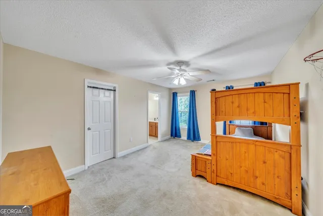 a bedroom with a bed and a ceiling fan
