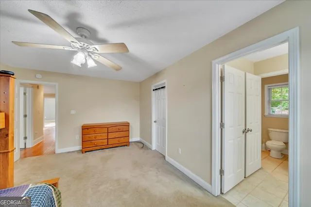 a spacious bedroom with a bed and a window