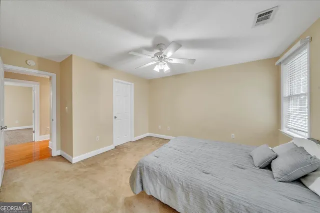 a view of living room filled with furniture and floor to ceiling window