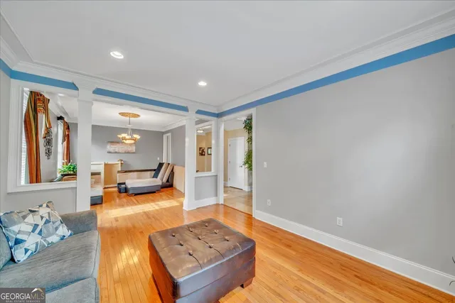 a view of a hallway with wooden floor and windows