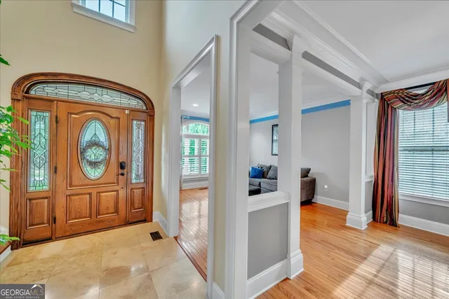 a living room with furniture a fireplace and a floor to ceiling window