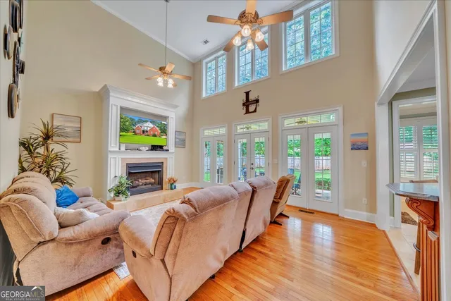 a living room with fireplace furniture and a chandelier
