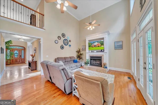 a view of a dining room with furniture large windows and wooden floor