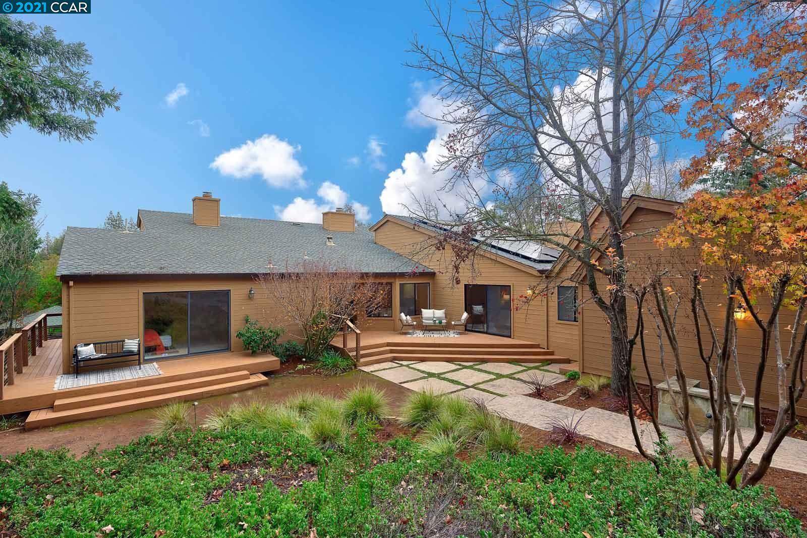 a backyard of a house with table and chairs
