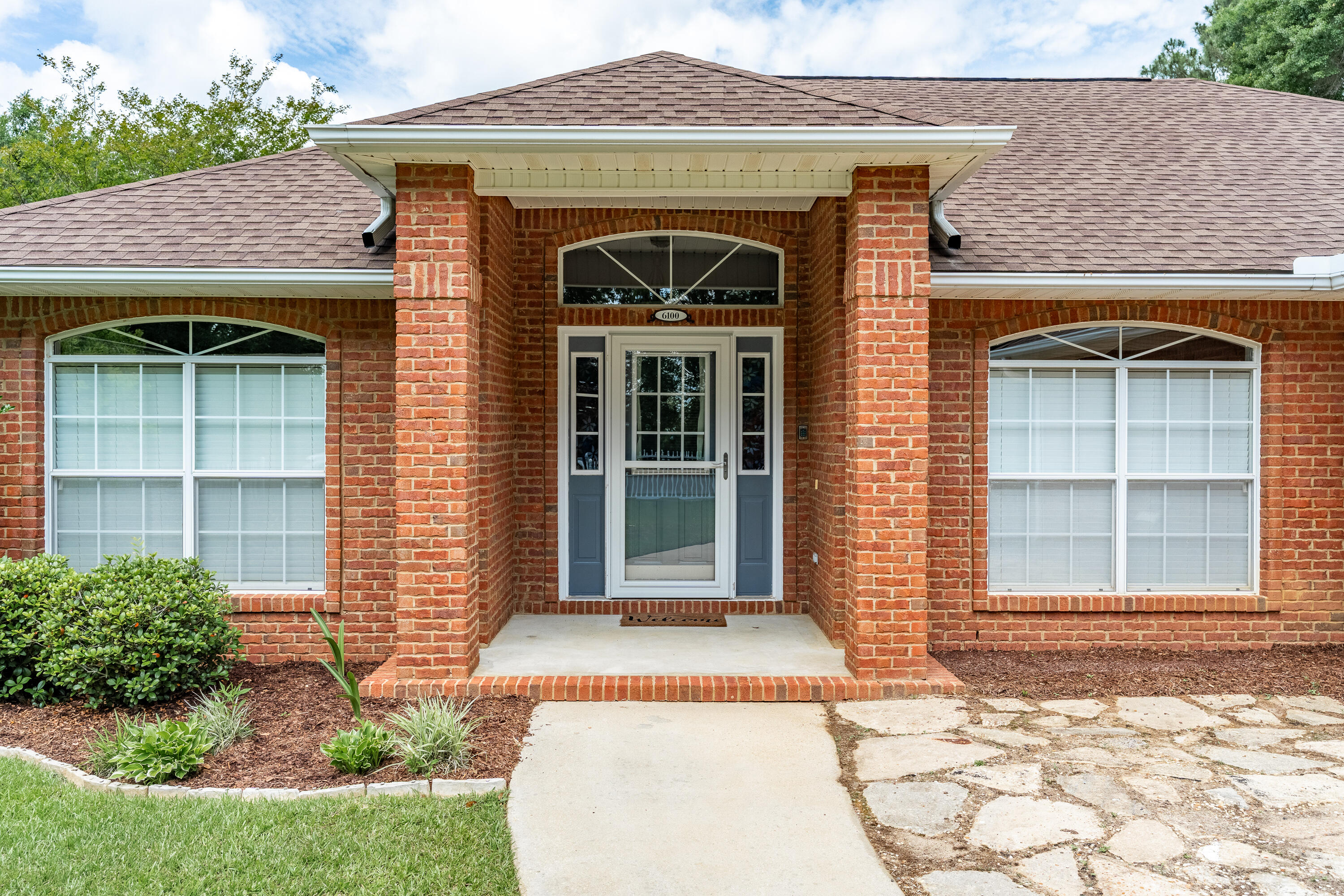 6100 Buckward Road Baker, FL 32531 - Photo 4 of 55 a front view of a house with a garden