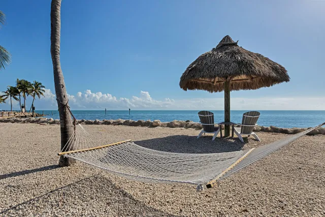 a balcony with chairs and a table