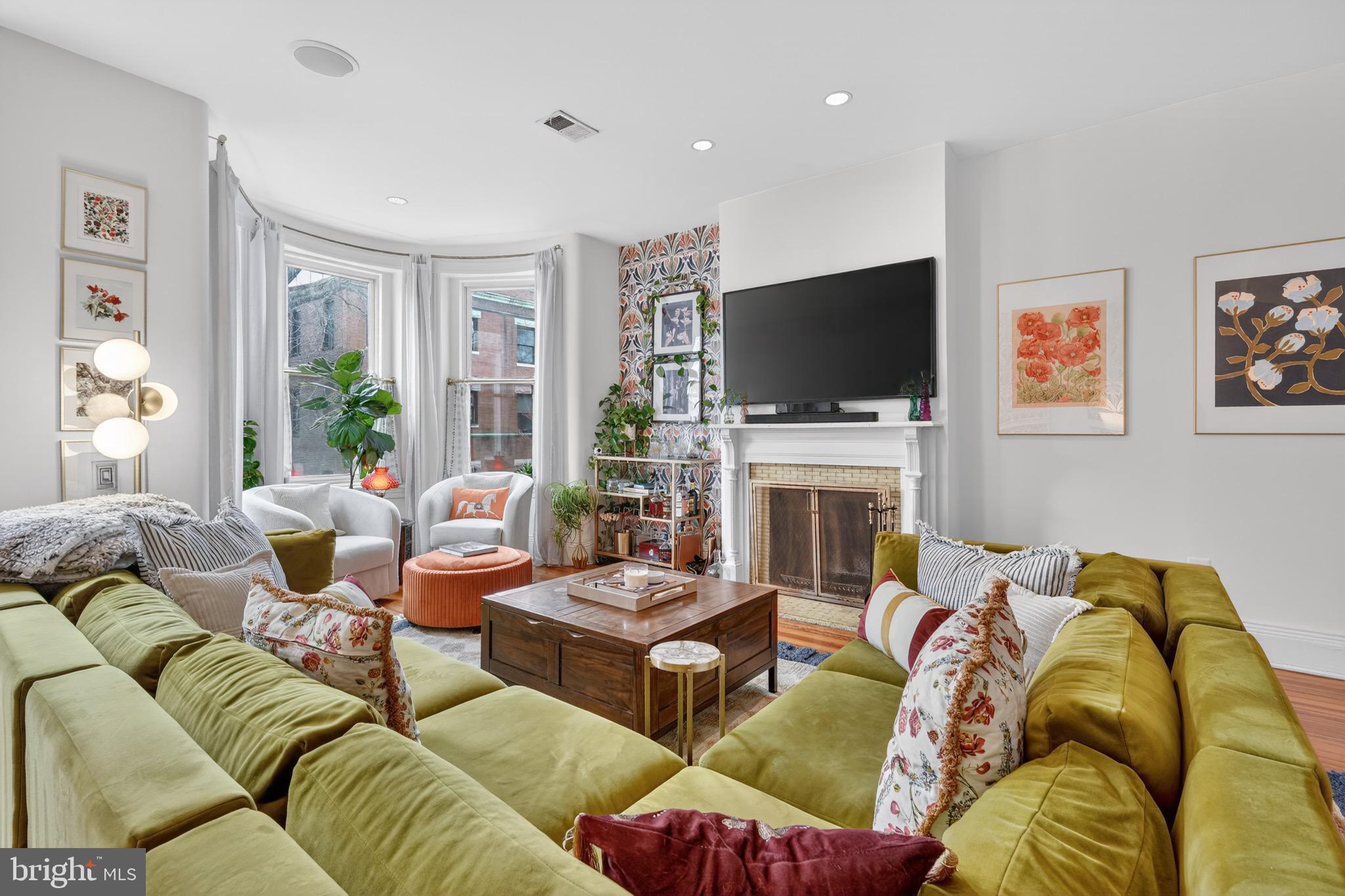 a living room with fireplace furniture and a flat screen tv