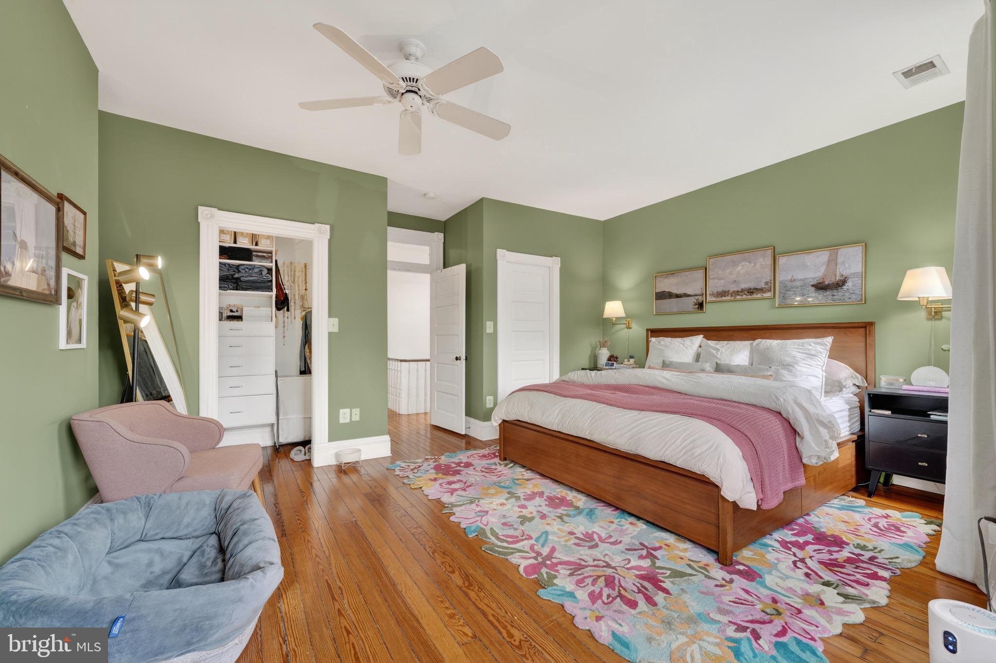 1731 Riggs Place Northwest, Unit 1 Washington, DC 20009 - Photo 6 of 20 a bedroom with a bed rug and wooden floor