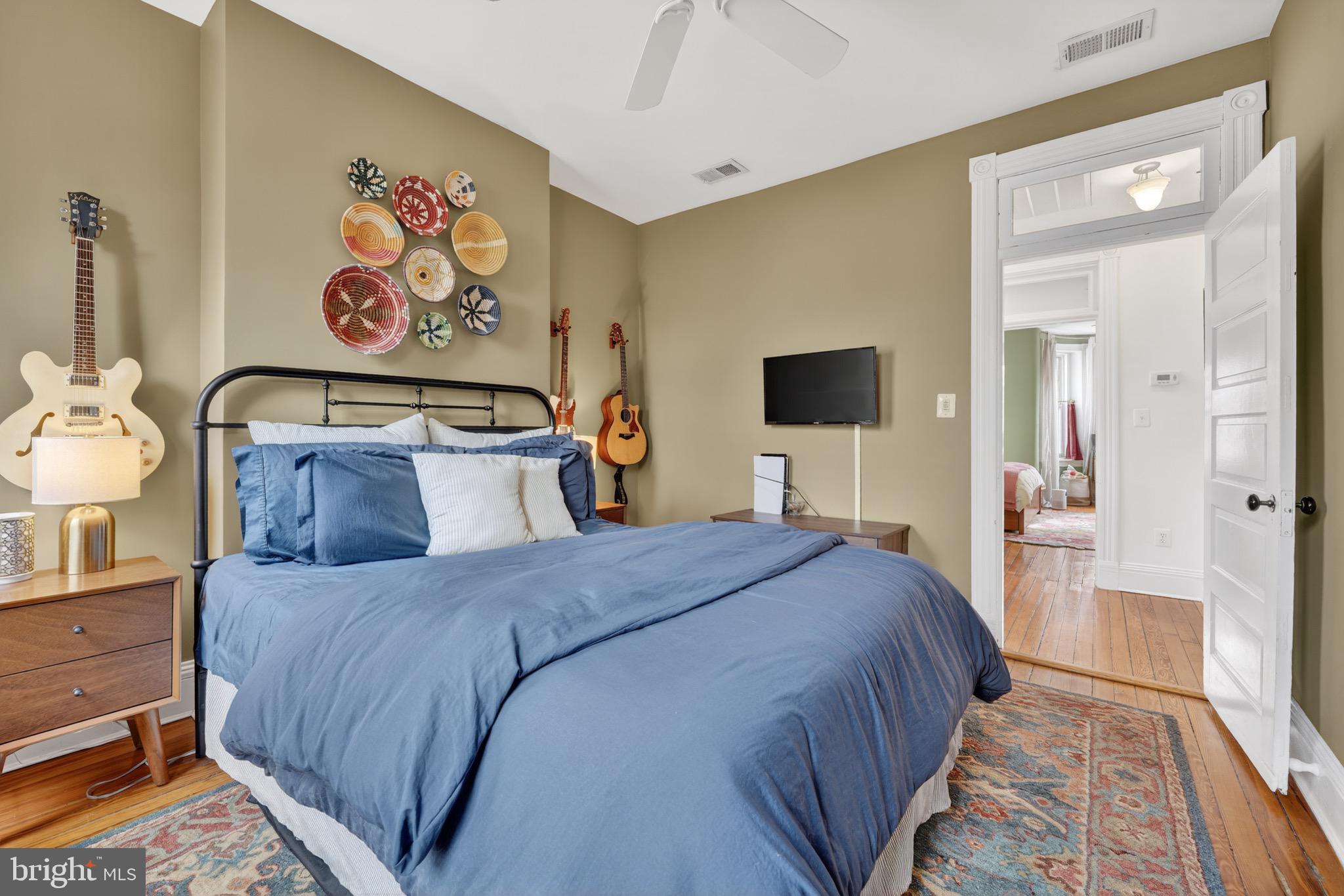 1731 Riggs Place Northwest, Unit 1 Washington, DC 20009 - Photo 8 of 20 a bedroom with a bed and painting on the wall
