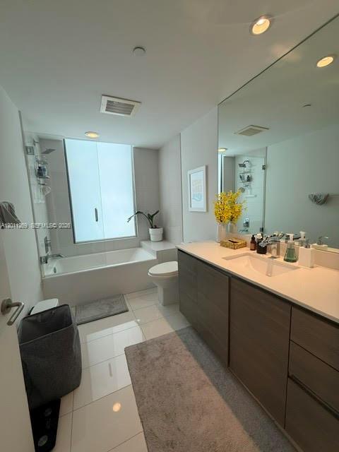 460 Northeast 28th Street, Unit 3408 Miami, FL 33137 - Photo 12 of 37 a bathroom with a double vanity sink a toilet and a mirror