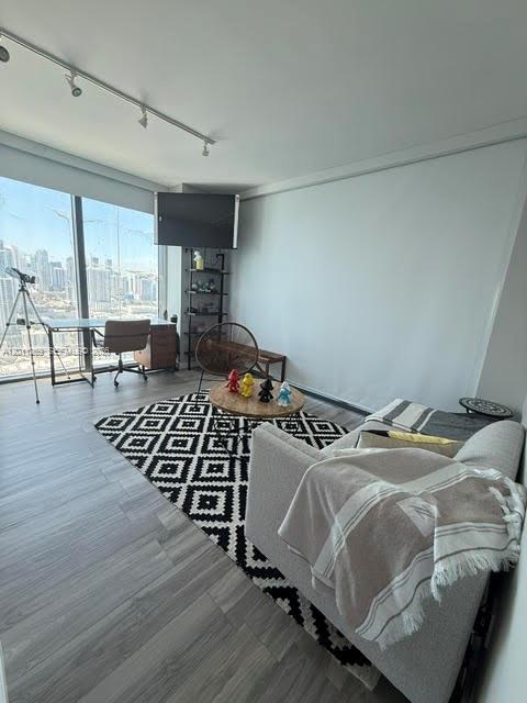 460 Northeast 28th Street, Unit 3408 Miami, FL 33137 - Photo 14 of 37 a bed sitting in a bedroom next to a window