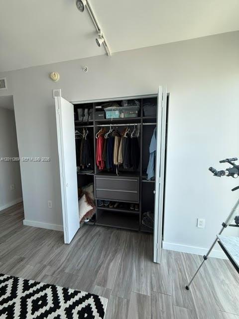 460 Northeast 28th Street, Unit 3408 Miami, FL 33137 - Photo 15 of 37 a view of walk in closet with clothes and shoes