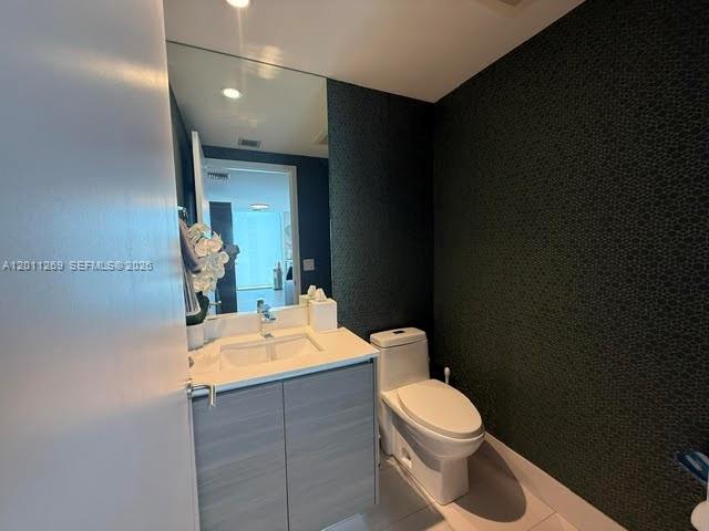 460 Northeast 28th Street, Unit 3408 Miami, FL 33137 - Photo 18 of 37 a bathroom with a sink a toilet and mirror