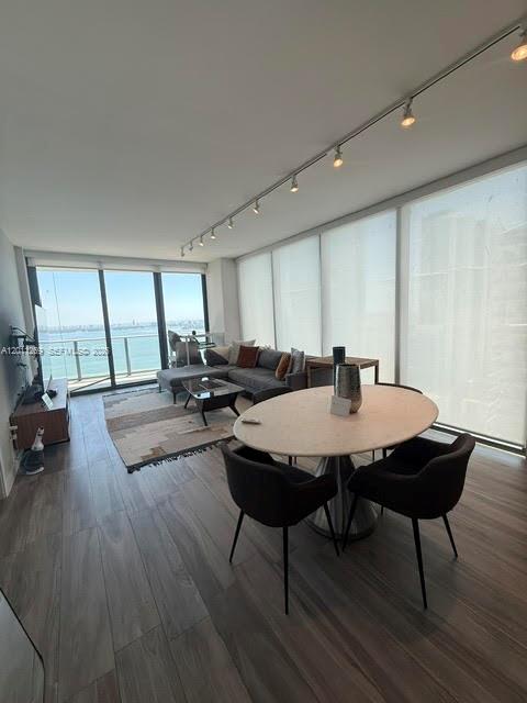 460 Northeast 28th Street, Unit 3408 Miami, FL 33137 - Photo 22 of 37 a view of a dining room with furniture and wooden floor