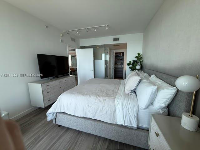 460 Northeast 28th Street, Unit 3408 Miami, FL 33137 - Photo 25 of 37 a bedroom with a bed and a flat screen tv