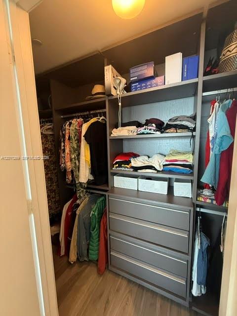 460 Northeast 28th Street, Unit 3408 Miami, FL 33137 - Photo 29 of 37 a view of walk in closet with clothes and shoes