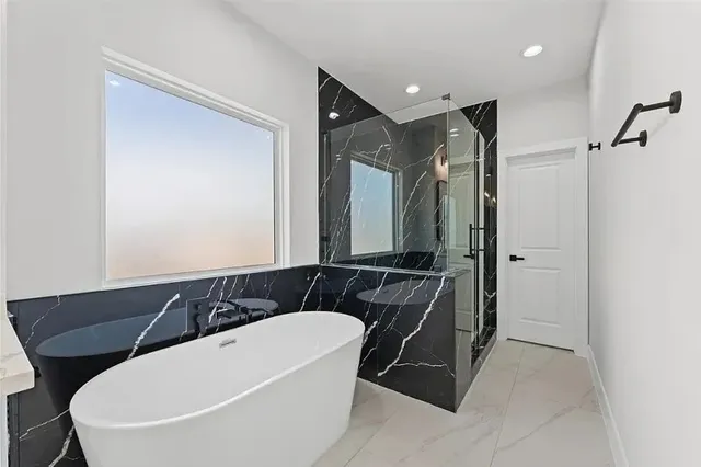 a bathroom with a bathtub and a sink