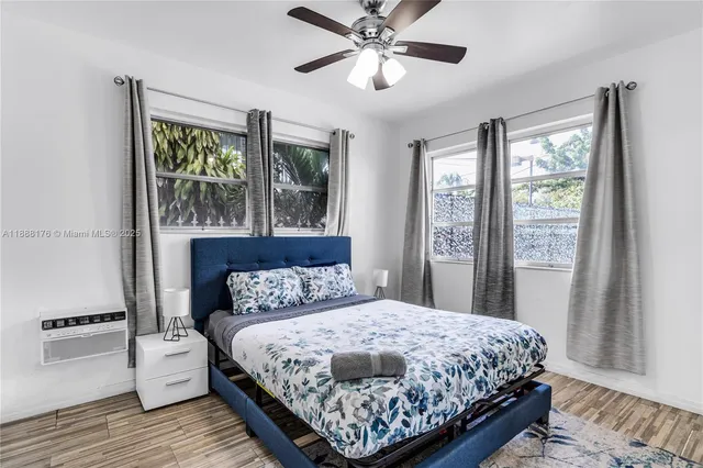 a bedroom with a large bed and a window