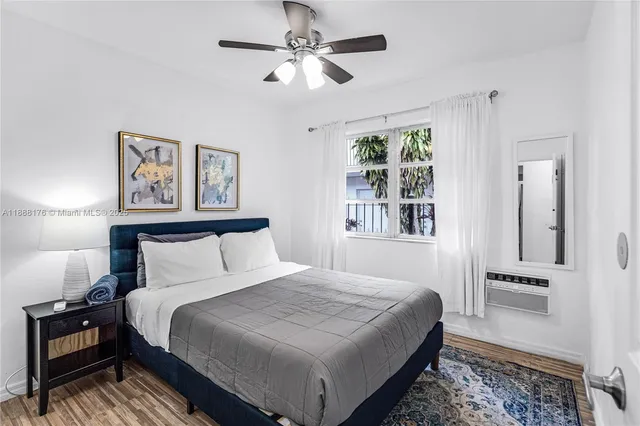 a bedroom with a large bed and a window