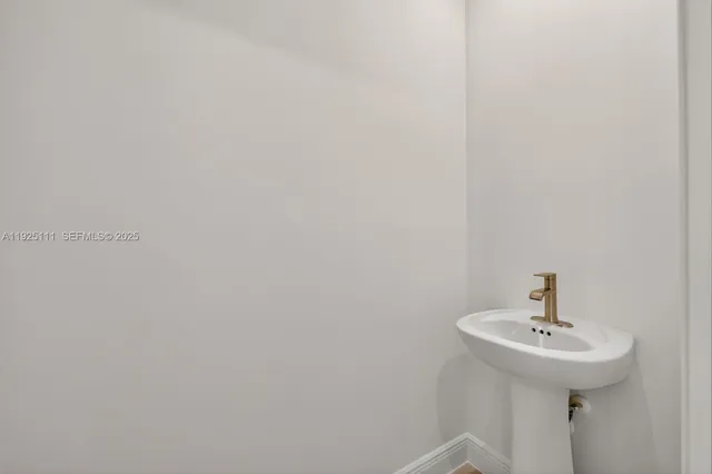 a bathroom with a sink and mirror