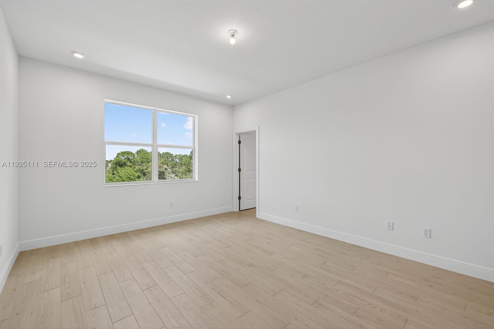 3585 Northwest Solange Court, Unit 3585 Jensen Beach, FL 34957 - Photo 19 of 33 an empty room with potted plants and more wall