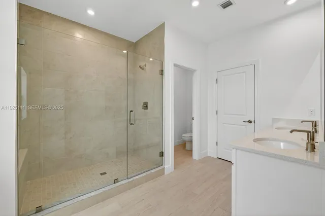 a bathroom with a shower and a sink