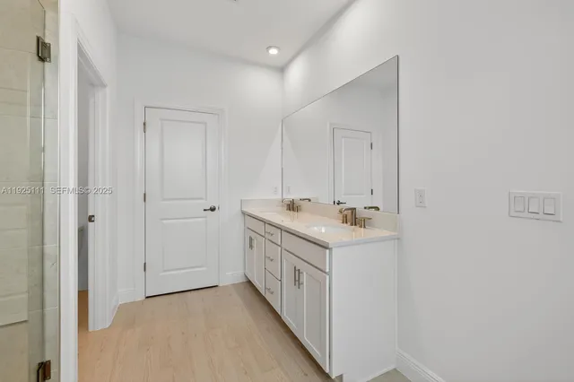 a room with a sink and a mirror