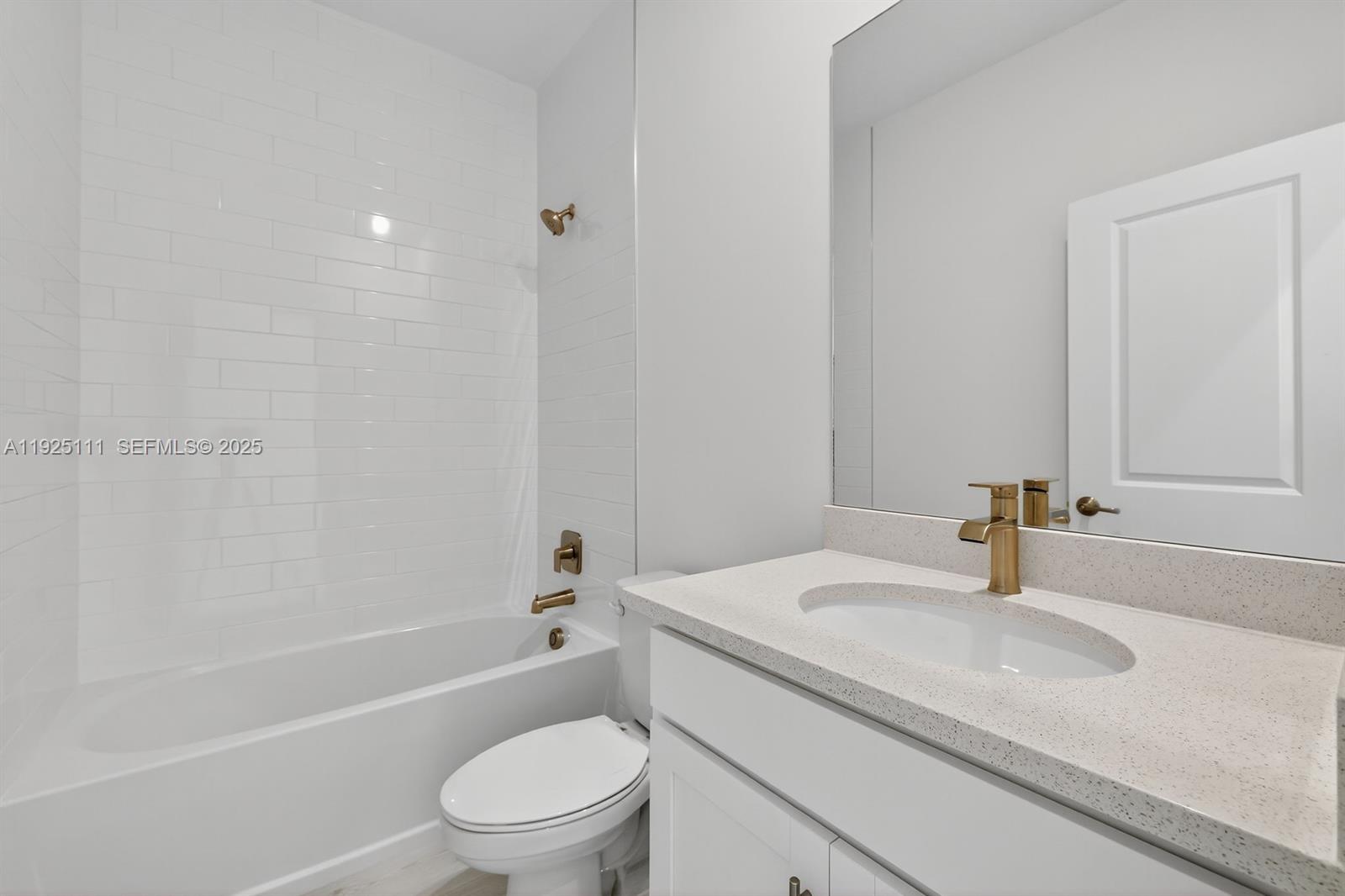 3585 Northwest Solange Court, Unit 3585 Jensen Beach, FL 34957 - Photo 24 of 33 a bathroom with a granite countertop sink a toilet and shower