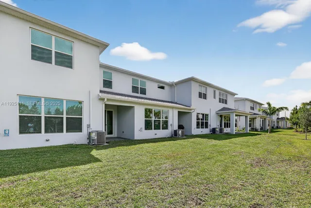 a view of a house with a yard and sitting area
