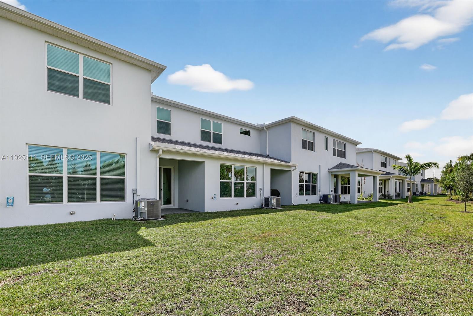 3585 Northwest Solange Court, Unit 3585 Jensen Beach, FL 34957 - Photo 30 of 33 a view of a house with a yard and sitting area