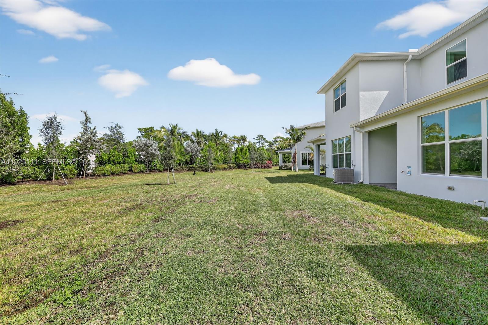 3585 Northwest Solange Court, Unit 3585 Jensen Beach, FL 34957 - Photo 33 of 33 a view of a house with a backyard