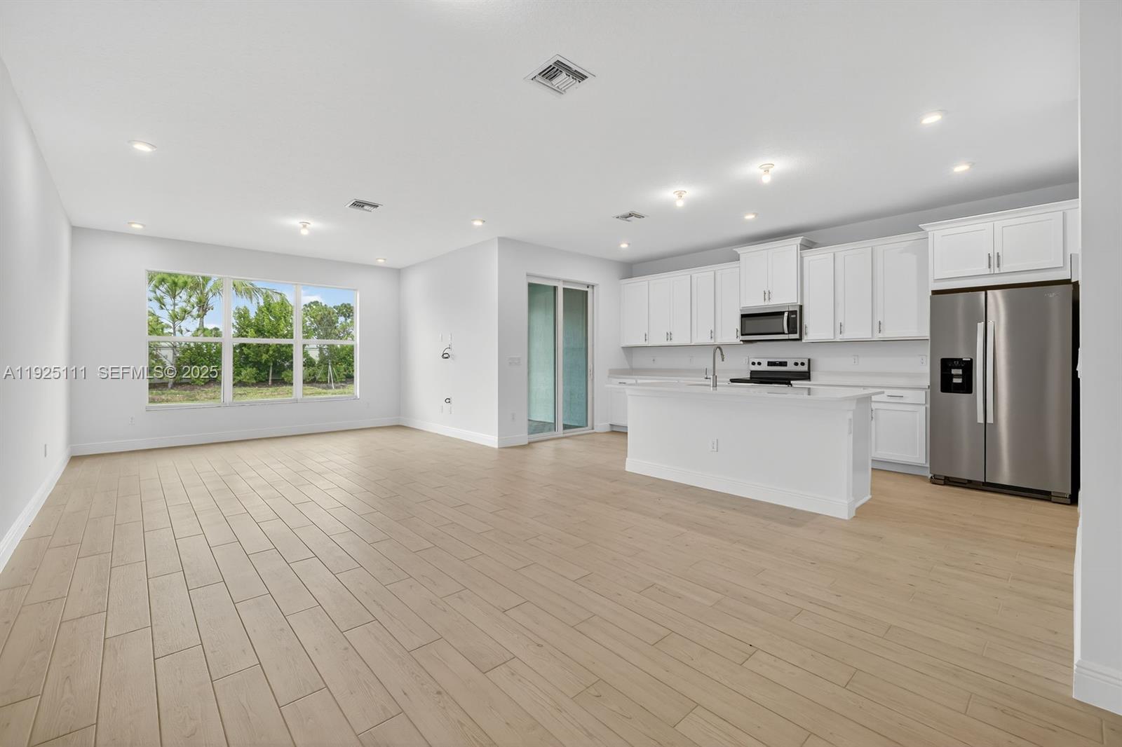 3585 Northwest Solange Court, Unit 3585 Jensen Beach, FL 34957 - Photo 5 of 33 a view of kitchen with wooden floor and electronic appliances