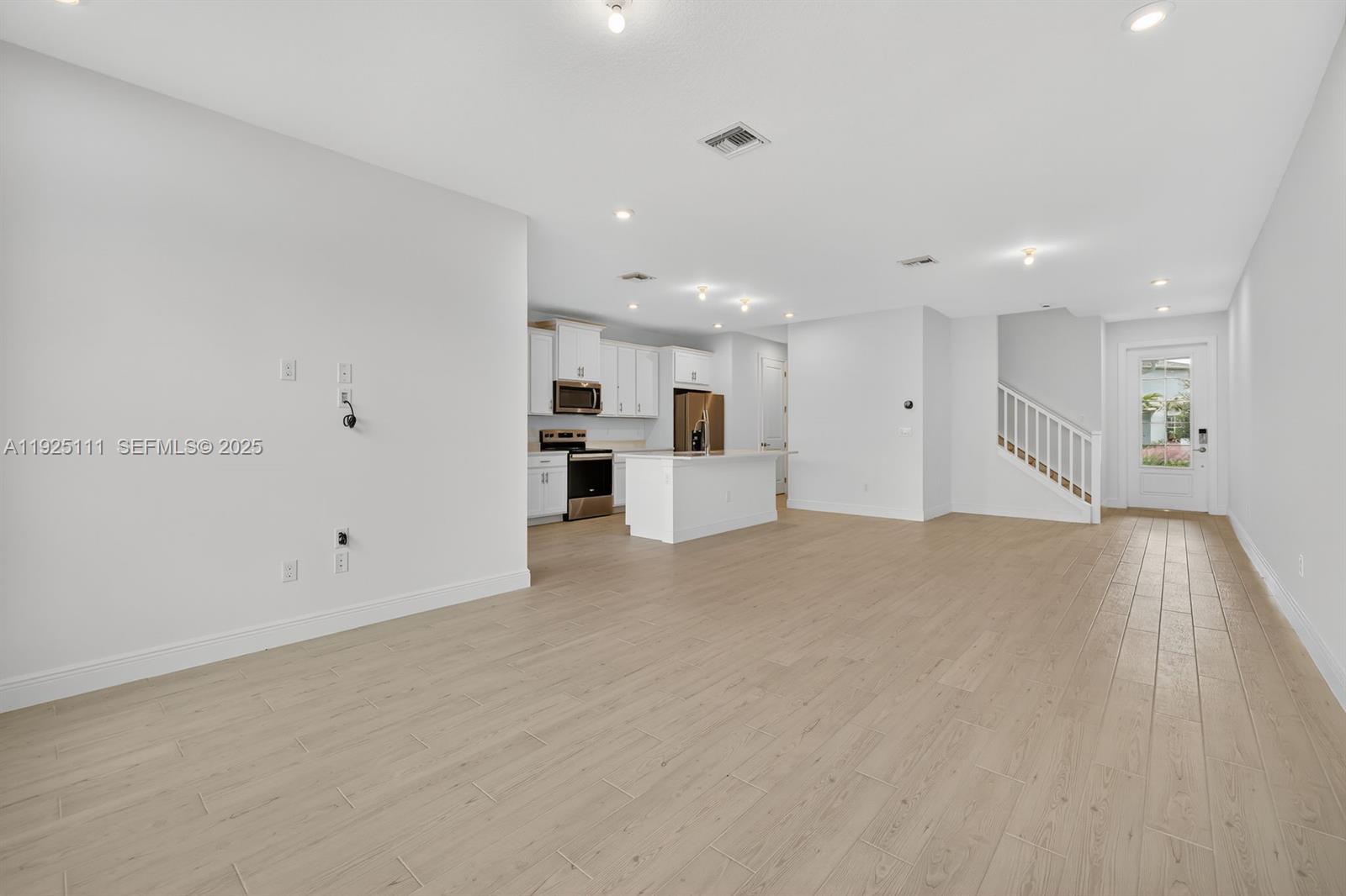 3585 Northwest Solange Court, Unit 3585 Jensen Beach, FL 34957 - Photo 6 of 33 a view of empty room with wooden floor
