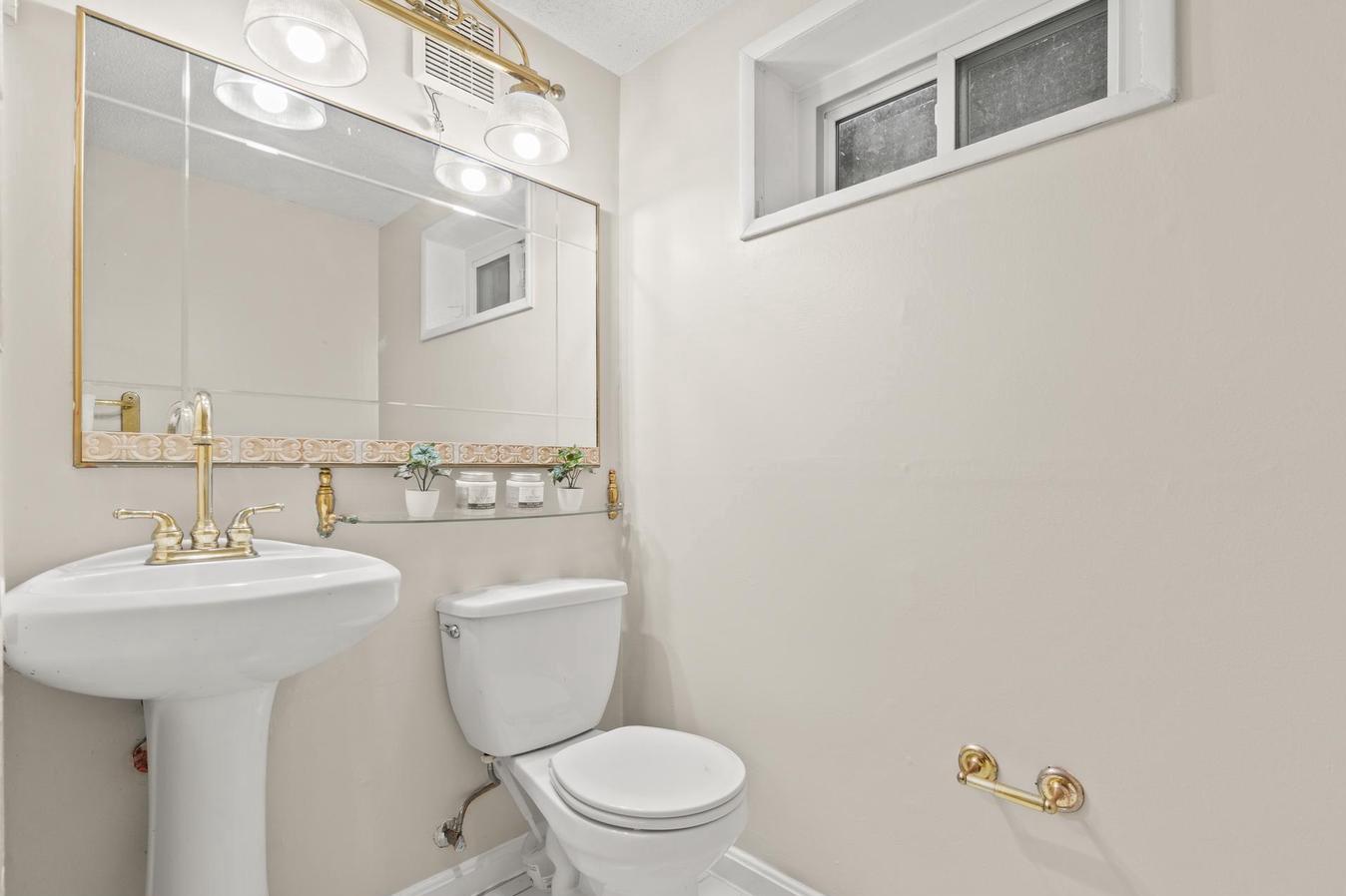 6505 Farley Street Springfield, VA 22152 - Photo 27 of 30 a bathroom with a toilet a sink and mirror
